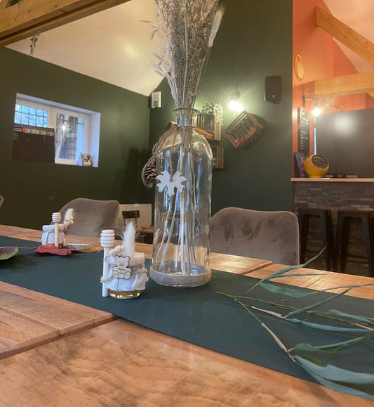 Gros plan sur le pot de miel Ourson décoré d’un ruban naturel et d’un bâton de miel